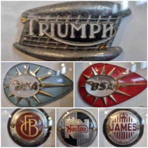 A collage showing several badges from motorcycles, including Triumph, BSA, Francis Barnett, Norton and James. They are shiny badges with colourful logos. 