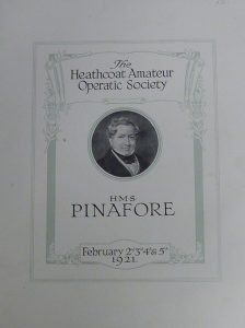 The front cover of a programme for 'HMS Pinafore' performed by The Heathcoat Operatic Society on February 2nd, 3rd, 4th and 5th 1921. There are decorative scrolls framing the programme and a portrait of John Heathcoat in the centre. 