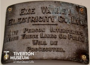 Sign reading 'Exe Valley Electricity Co. Ltd. Any Person Interfering With These Lines Or Poles Will Be Prosecuted.' 