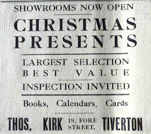 Newspaper cutting reading 'Showrooms now open. Christmas presents. Largest selection. Best Value. Inspection Invited. Books, Calendars, Cards. Thos. Kirk 19, Fore Street, Tiverton'